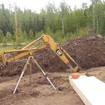 Back hoe, digging into the ground.