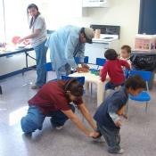 Philomena at the snack table 
Homer Meekis the Health Director putting snacks for the two kids,
Rayleen you can guess what she